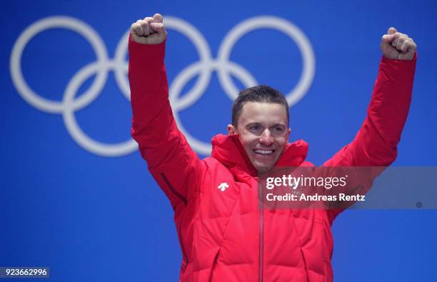 Gold medalist Nevin Galmarini of Switzerland celebrates during the medal ceremony for Mens Snowboard Parallel Giant Slalom on day fifteen of the...