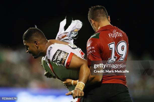 Nene MacDonald of the Dragons is tackled by Braidon Burns of the Rabbitohs during the NRL trial match between the South Sydney Rabbitohs and the St...