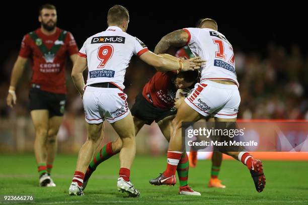 Robbie Farah of the Rabbitohs is tackled during the NRL trial match between the South Sydney Rabbitohs and the St George Illawarra Dragons at Glen...