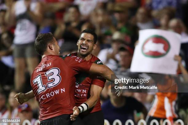 Cody Walker of the Rabbitohs celebrates scoring a try with team mate Sam Burgess of the Rabbitohs during the NRL trial match between the South Sydney...