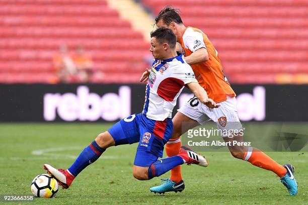 Wayne Brown of the Jets and Brett Holman of the Roar compete for the ball during the round 21 A-League match between the Brisbane Roar and Newcastle...