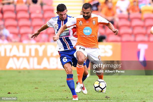 Steven Ugarkovic of the Jets and Fahid Ben Khalfallah of the Roar challenge for the ball during the round 21 A-League match between the Brisbane Roar...