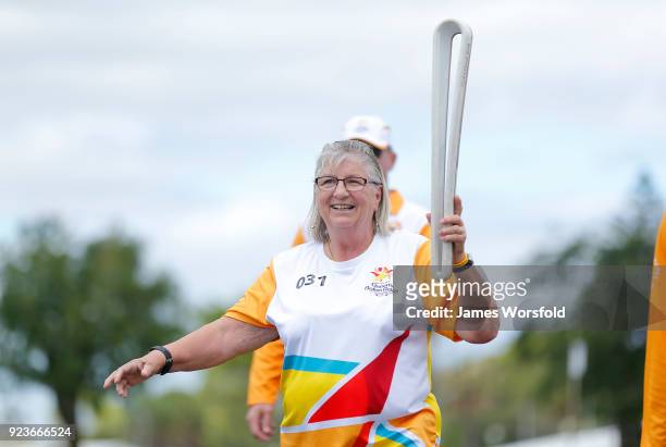 Joyce McGinn hold the baton as she walks her leg of the Queens Baton Commonwealth Games relay in Bunbury on February 23, 2018 in Bunbury, Australia.