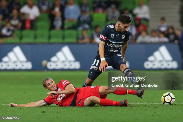 Christian Theoharous of the Victory is tackled during the round 21 A-League match between the Melbourne Victory and Adelaide United at AAMI Park on...