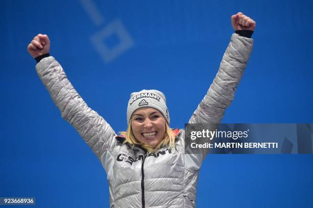 Germany's silver medallist Selina Joerg poses on the podium during the medal ceremony for the snowboard women's parallel giant slalom at the...