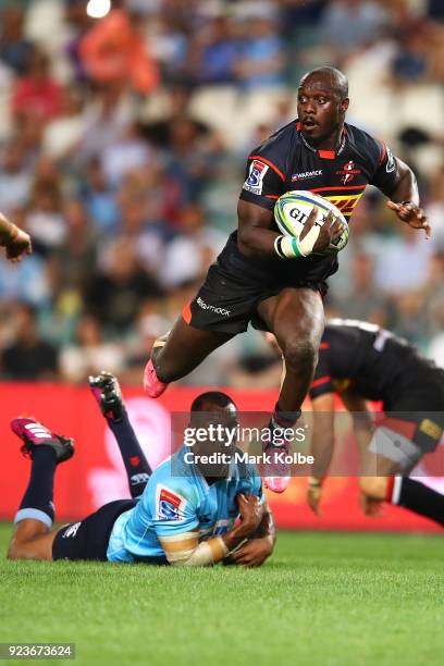 Raymond Rhule of the Stormers jumps to evade the tackle of Kurtley Beale of the Waratahs during the round two Super Rugby match between the Waratahs...