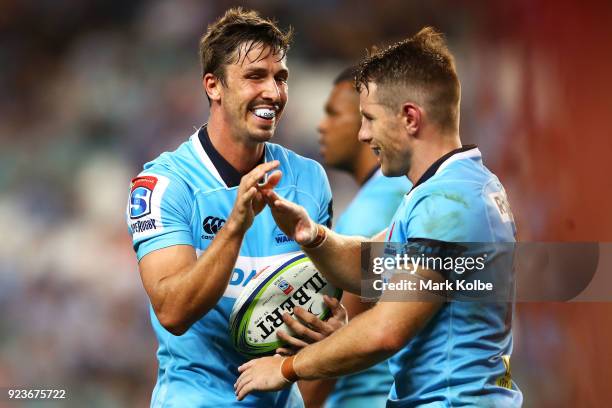 Jake Gordon and Bernard Foley of the Waratahs high five during the round two Super Rugby match between the Waratahs and the Stormers at Allianz...