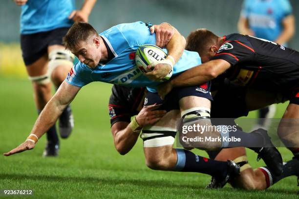 Jed Holloway of the Waratahs is tackled during the round two Super Rugby match between the Waratahs and the Stormers at Allianz Stadium on February...
