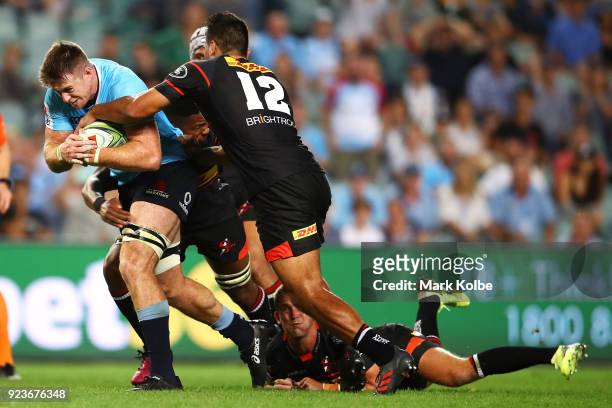 Jed Holloway of the Waratahs is tackled during the round two Super Rugby match between the Waratahs and the Stormers at Allianz Stadium on February...