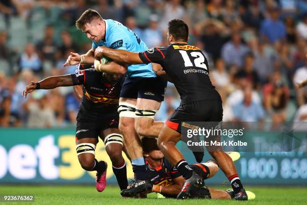 Jed Holloway of the Waratahs is tackled during the round two Super Rugby match between the Waratahs and the Stormers at Allianz Stadium on February...