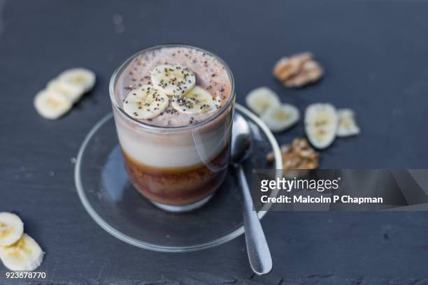 banana latte, coffee drink, served with walnuts and chia seeds - p nut stock pictures, royalty-free photos & images