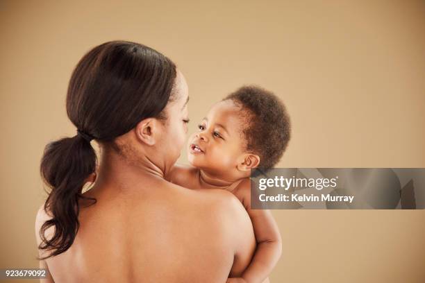 mother holding baby girl (13-14 months) - families nude stock pictures, royalty-free photos & images