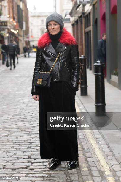 Stylist and editor Steph Wilson wears a Shrimps jacket, And Other Stories trousers and hat, and Miu Miu bag on day 5 of London Womens Fashion Week...