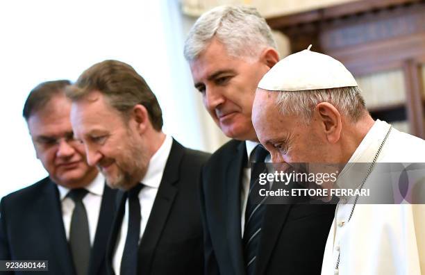 Pope Francis smiles as he meets the three members of Bosnia's tripartite presidency Mladen Ivanic , Bakir Izetbegovic , and Dragan Covic during a...