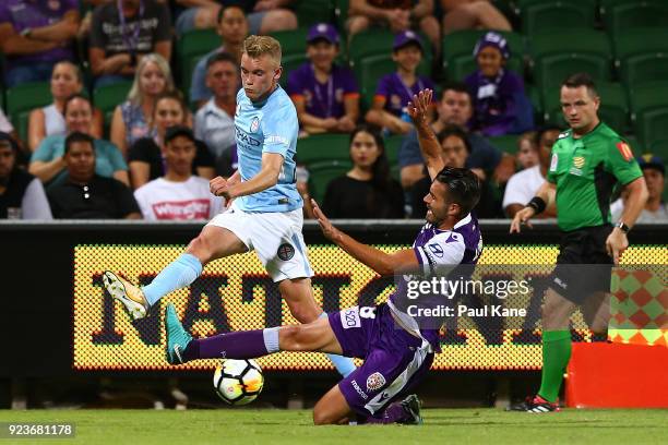 Xavier Torres of the Glory blocks a cross by Nathaniel Atkinson of Melbourne during the round 21 A-League match between the Perth Glory and Melbourne...