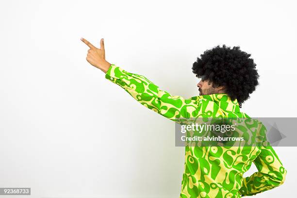 1970s disco dude points to left - afro wig stock pictures, royalty-free photos & images