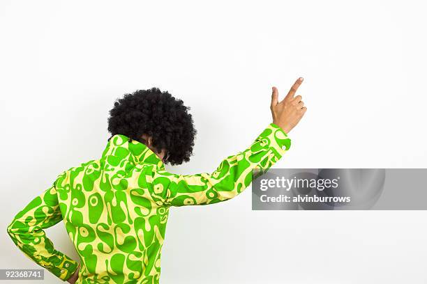 1970s styled disco dude points upward. - white afro wig stock pictures, royalty-free photos & images