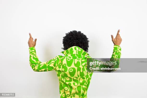 1970s disco dude points upward. - afro wig stock pictures, royalty-free photos & images