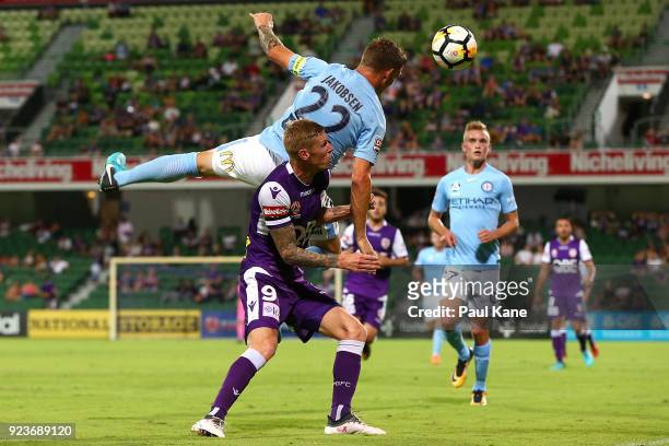 Michael Jakobsen of Melbourne contests a header against Andy Keogh of the Glory during the round 21 A-League match between the Perth Glory and...
