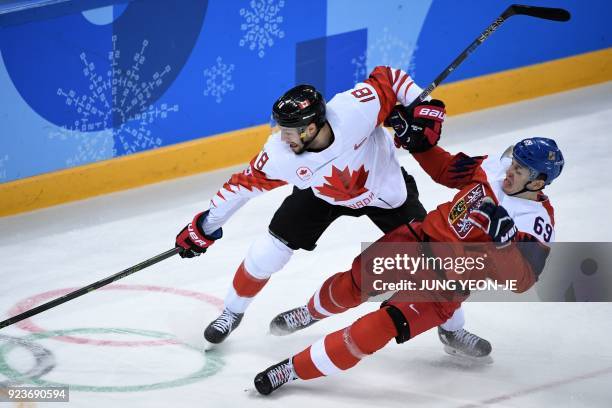 Canada's Marc-Andre Gragnani and Czech Republic's Lukas Radil fight for the puck in the men's bronze medal ice hockey match between the Czech...