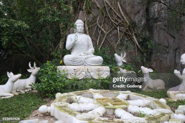 Marble moutain. Shakyamuni Buddha with Dharma Wheel. Marble statue. Danang, Vietnam.