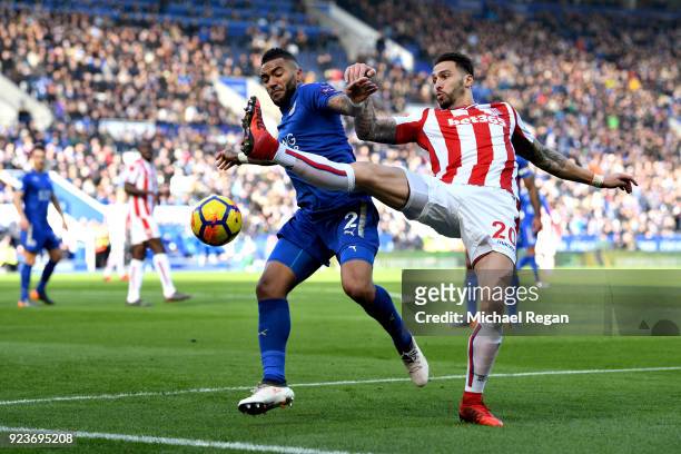 Danny Simpson of Leiceter City battles for possesion with Geoff Cameron of Stoke City during the Premier League match between Leicester City and...