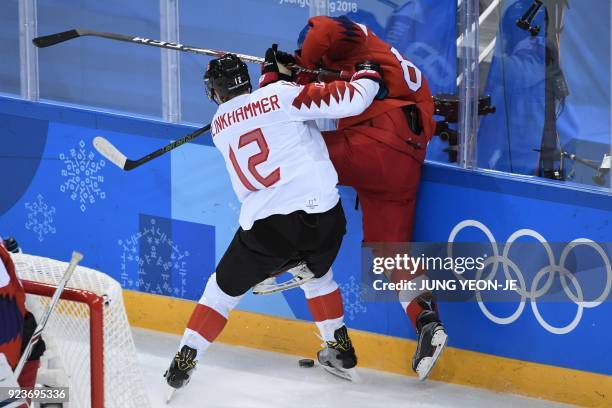 Canada's Rob Klinkhammer collides with a Czech Republic player in the men's bronze medal ice hockey match between the Czech Republic and Canada...