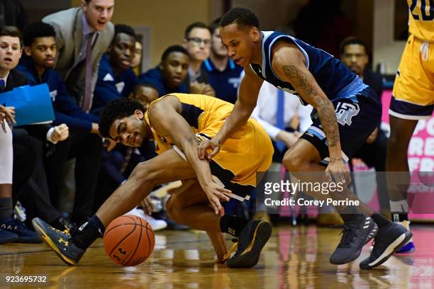 Pookie Powell of the La Salle Explorers loses the ball against Fatts Russell of the Rhode Island Rams during the first half at Tom Gola Arena on...