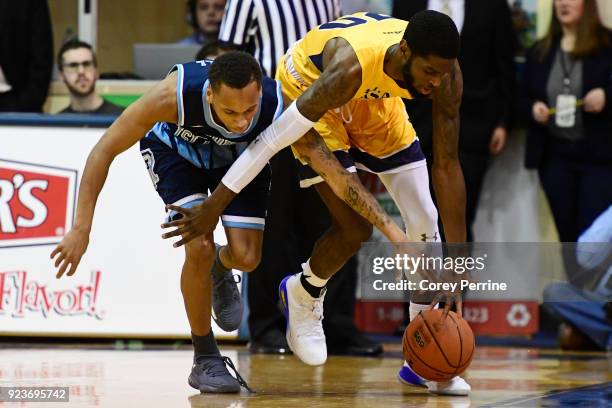Fatts Russell of the Rhode Island Rams reaches in on B.J. Johnson of the La Salle Explorers during the first half at Tom Gola Arena on February 20,...