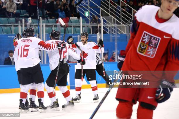 Chris Kelly of Canada celebrates with teammates after scoring in the first period against Czech Republic during the Men's Bronze Medal Game on day...