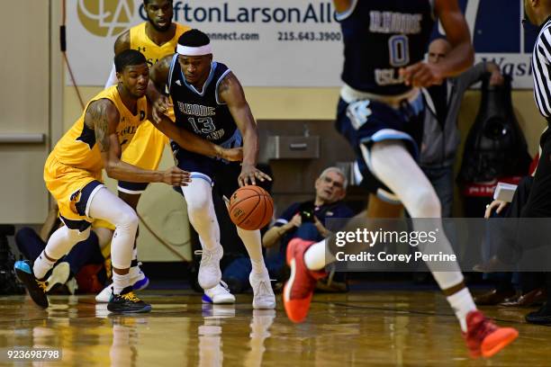 Amar Stukes of the La Salle Explorers reaches in, drawing the foul, on Stanford Robinson of the Rhode Island Rams during the first half at Tom Gola...