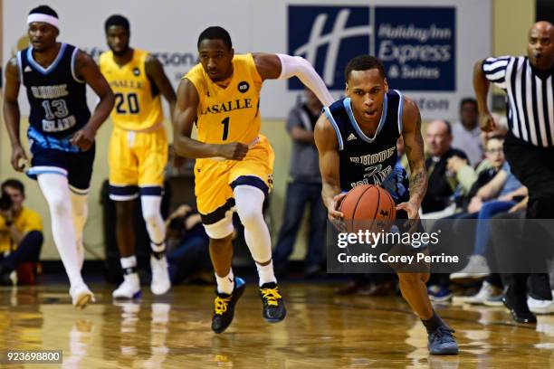 Fatts Russell of the Rhode Island Rams scoops up the ball against the La Salle Explorers during the first half at Tom Gola Arena on February 20, 2018...