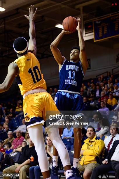 Jeff Dowtin of the Rhode Island Rams shoots the ball against Isiah Deas of the La Salle Explorers during the first half at Tom Gola Arena on February...