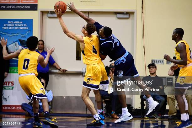 Andre Berry of the Rhode Island Rams reaches for the ball against Miles Brookins of the La Salle Explorers during the second half at Tom Gola Arena...