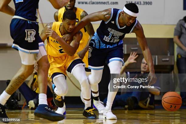 Stanford Robinson of the Rhode Island Rams is fouled by Amar Stukes of the La Salle Explorers during the first half at Tom Gola Arena on February 20,...