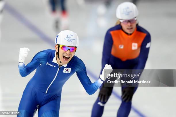 Seung-Hoon Lee of Korea celebrates winning the gold medal as Koen Verweij of Netherlands takes the bronze during the Men's Speed Skating Mass Start...