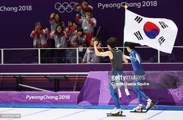 Seung-Hoon Lee of Korea celebrates winning the gold medal with teammate Jaewon Chung of Korea during the Men's Speed Skating Mass Start Final on day...