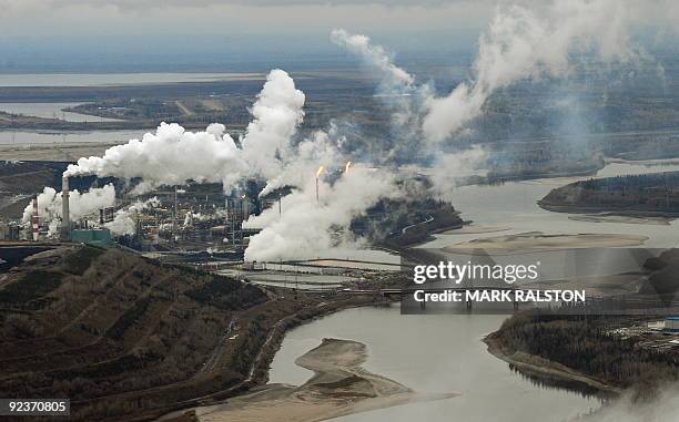 Aerial view of the Suncor oil sands extraction facility on the banks of the Athabasca River and near the town of Fort McMurray in Alberta Province,...