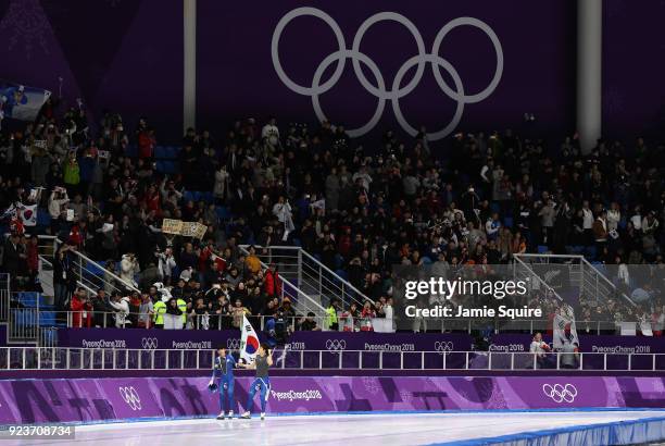 Seung-Hoon Lee of Korea celebrates winning the gold medal with teammate Jaewon Chung of Korea during the Men's Speed Skating Mass Start Final on day...