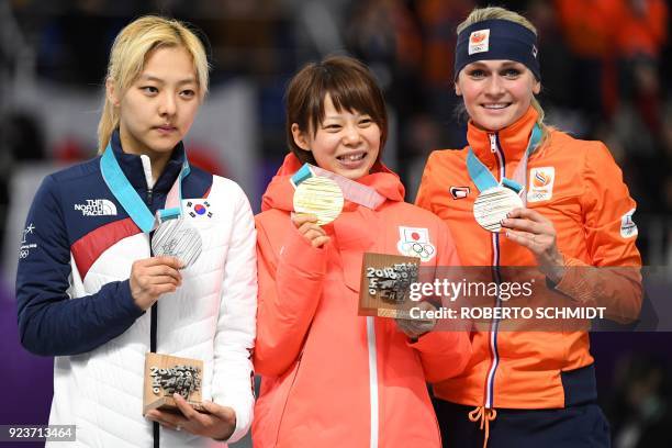 Japan's Nana Takagi , South Korea's Kim Bo-Reum and Netherlands' Irene Schouten celebrate their respective gold, silver and bronze medals on the...