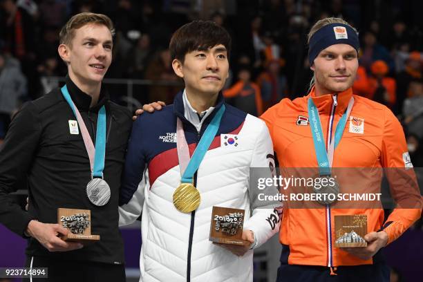 South Korea's Lee Seung-Hoon , Belgium's Bart Swings and Netherlands' Koen Verweij pose on the podium as they celerbate their respective gold, silver...