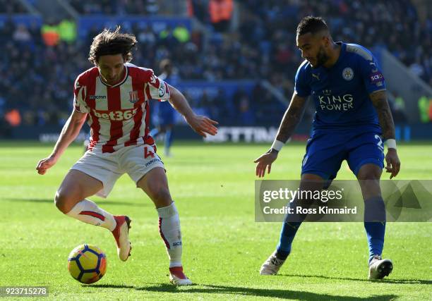 Joe Allen of Stoke City is challenged by Danny Simpson of Leiceter City during the Premier League match between Leicester City and Stoke City at The...