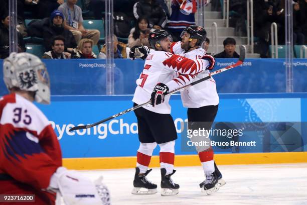 Andrew Ebbett of Canada celebrates scoring in the third period with Brandon Kozun against Pavel Francouz of the Czech Republic during the Men's...