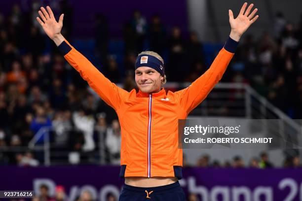 Netherlands' Koen Verweij celebrates his bronze medal on the podium during the men's mass start speed skating event medal ceremony during the...