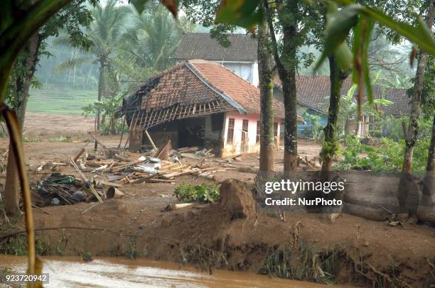 Residents clear roads and save valuables when landslides hit dozens of houses and blocked access roads in Pasir Panjang village, Brebes, Central Java...