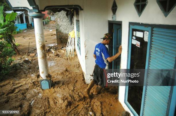 Residents clear roads and save valuables when landslides hit dozens of houses and blocked access roads in Pasir Panjang village, Brebes, Central Java...