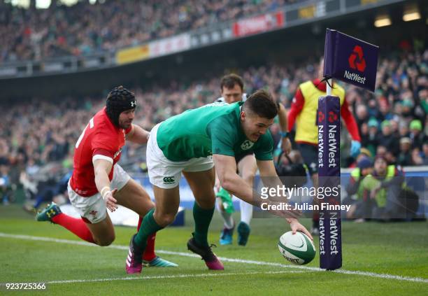 Jacob Stockdale of Ireland dives in for a first half try under pressure from Leigh Halfpenny of Wales during the NatWest Six Nations match between...