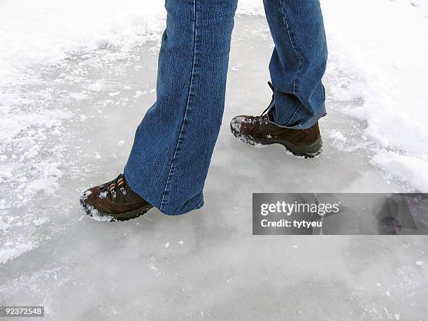 feet on ice - shoe covers stock pictures, royalty-free photos & images