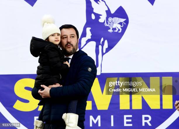 Lega Nord leader Matteo Salvini holds his daughter Mirta on arrival to a campaign rally on Piazza Duomo in Milan on February 24, 2018 a week ahead of...