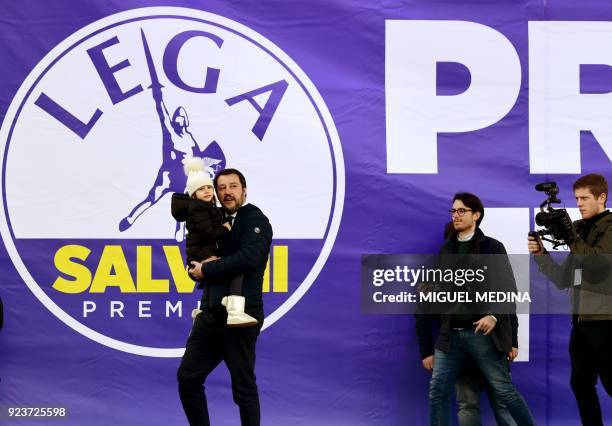 Lega Nord leader Matteo Salvini holds his daughter Mirta on arrival to a campaign rally on Piazza Duomo in Milan on February 24, 2018 a week ahead of...